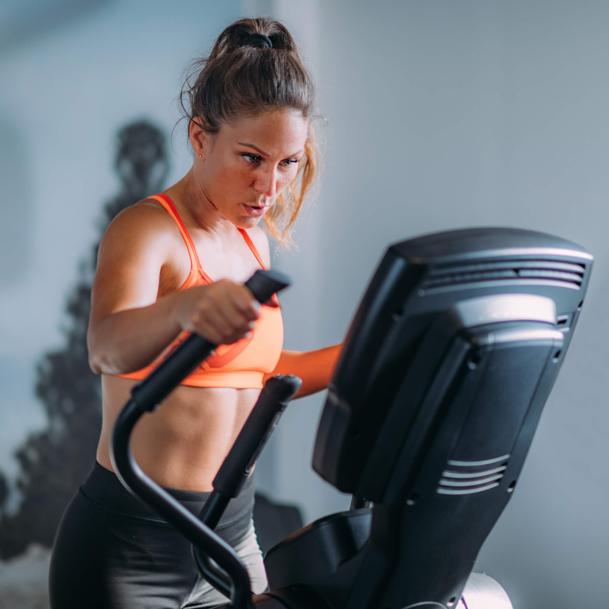 woman-exercising-on-elliptical-cross-trainer-2023-11-27-05-07-01-utc.jpg